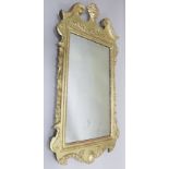 A GEORGE II DESIGN GILDED PIER MIRROR, scrolling broken pediment with central vase of flowers crest,