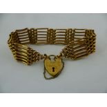 A GOLD COLOURED METAL SIX BAR PADLOCK BRACELET with hallmarked clasp