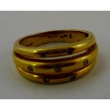 A 1970's 18CT GOLD DIAMOND DRESS RING having three bands set with seven diamonds, size O easy