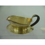 BLANCKENSEE & SONS AN OVAL SILVER SAUCE BOAT having thickened rim, oval foot and fibre handle,