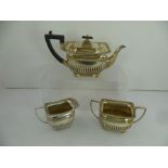 GOLDSMITHS & SILVERSMITHS COMPANY AN EDWARDIAN SILVER THREE PIECE TEA SET of Georgian design