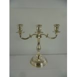 A 20TH CENTURY FOREIGN SILVER COLOURED METAL THREE-LIGHT TWO-BRANCH CANDELABRUM, having tooled