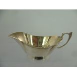 ROBERTS & DORE A SILVER SAUCE BOAT, having applied beaded rim and cast handle, Birmingham 1947,