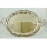 A 20TH CENTURY FOREIGN SILVER COLOURED METAL OVAL DRINKS TRAY, having twin cast loop handles, cast