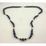 A LAPIS LAZULI NECKLACE interspersed with 9ct gold bars and a 9ct gold bolt ring clasp, 86cm long