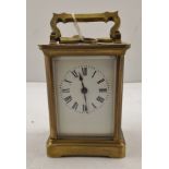 A 20TH CENTURY FRENCH GILT BRASS CARRIAGE TIMEPIECE, having shaped swing handle, movement with