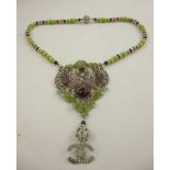 CHANEL A DIAMANTE PENDANT NECKLACE with green and red beads, peacocks and motifs, 50cm long