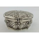 A FOREIGN SILVER COLOURED METAL TRINKET BOX having fancy floral worked top with un-engraved