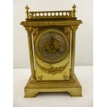 A LATE 19TH CENTURY BRASS CASED MANTEL CLOCK, with balustrade top over egg and dart frieze, the body