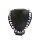 A GLOBULAR CHEVRON AMETHYST BEAD NECKLACE with silver coloured metal bolt ring clasp, 55cm long