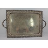 A GEORGE V EPNS RECTANGULAR DRINKS TRAY having richly cast applied and repousse floral border and