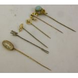 A SELECTION OF SIX GOLD AND GOLD COLOURED METAL TIE PINS, including cabochon turquoise matrix, cameo