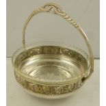 A SILVER PLATED FRUIT BASKET in the style of WMF, the bowl, having pierced up and over handle,