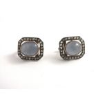 A PAIR OF DECO STYLE SAPPHIRE AND DIAMOND GOLD MOUNTED STUD EARRINGS, each having an oval cabochon