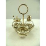 CHRISTOPHER DRESSER FOR HUKIN & HEATH A SILVER AND GLASS THREE-PIECE CRUET, having ring handled