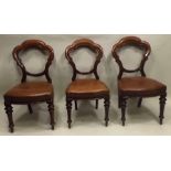 A SET OF SIX LATE VICTORIAN MAHOGANY CROWN BACK SINGLE DINING CHAIRS having studded hide seats, on