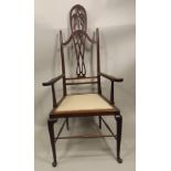 A 1920'S MAHOGANY HIGH BACK OPEN ARM CHAIR, having fretted tear drop splat, swept arms,