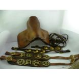 A QUANTITY OF HORSE TACK includes; a pony saddle, straps of horse brasses etc.