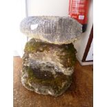 A CAST CONCRETE AMMONITE on rock work style plinth, 45cm high