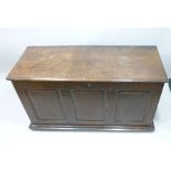 A 19TH CENTURY OAK COFFER (with later alterations) having plank top with moulded edge over a