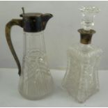 AN EDWARDIAN SILVER MOUNTED CUT CRYSTAL GLASS CLARET JUG having plain hinged lid cover with