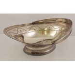 A LATE PERIOD SHEFFIELD PLATE OVAL FRUIT BASKET having swing handle, fretted and tooled with