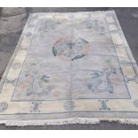 A CHINESE CARPET having pale grey ground with carved pastel coloured central five toed dragon amidst