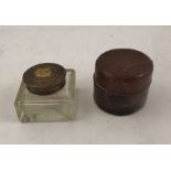 A LEATHER CLAD TRAVELLERS INKWELL 5cm diameter with another brass capped square glass well (2)