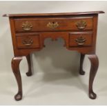 A PRINCIPALLY GEORGE III WALNUT LOWBOY, having plank top with moulded edge over one long and two