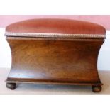 A 19TH CENTURY MAHOGANY BOX OTTOMAN of waisted form with hinged upholstered top, raised on ball feet