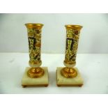 A PAIR OF EMPIRE DESIGN GILDED CHAMPLEVE CYLINDER FORM BUD VASES, raised on square onyx bases with