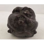 A JAPANESE PATINATED BRONZE OF THREE MONKEYS entwined in a ball, symbolizing "see no evil, hear no