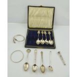 TWO SILVER GOLF TROPHY SPOONS one with a cast terminal depicting early 20th century golfers at the