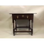 A GEORGE III OAK SINGLE DRAWER SIDE TABLE with brass dropper handles, on turned supports with