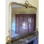 A 19TH CENTURY GILT FRAMED OVERMANTEL MIRROR, having ribbon crest, leaf and berry decorated frame