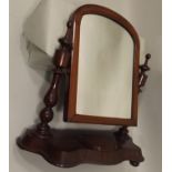 A LATE VICTORIAN MAHOGANY TOILET MIRROR, having arched plain plate twin baluster turned horns on a