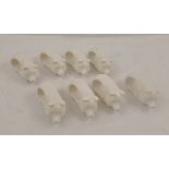 A SET OF EIGHT GLAZED PARIAN PIG FORM NAPKIN RINGS, 8cm