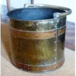 A CYLINDRICAL BRASS COAL BUCKET with copper bands and swing handle, 37cm diameter