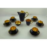 A 1960's JERSEY POTTERY COFFEE SET having gilded bowl and rim with blue ground, set of six coffee