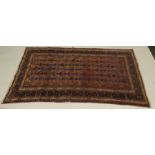 A PERSIAN RUG, brick ground central field with bands of blue and dark brown stylised designs,