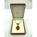 AN OVAL BACCARAT PENDANT cut intaglio with classical figure and angel