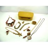 A BOX OF COSTUME JEWELLERY to include; simulated amethyst, cameo pendants etc.