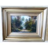 BRITISH SCHOOL Rural scene, Figures on a woodland path, Oil on canvas, in deep moulded gilt frame