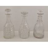 THREE SIMILAR CUT LEAD DECANTERS, mallet shaped, each with mushroom stopper