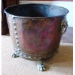 A RIVETTED COPPER COAL BIN with brass lion mask handles, on brass feet, together with one other