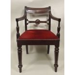 A FIRST QUARTER 19TH CENTURY MAHOGANY FINISHED ARMCHAIR, with reeded bar back and swept arms and