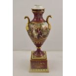 F. KOLLER A LATE 19TH CENTURY VIENNA PORCELAIN PEDESTAL VASE AND COVER glazed in burgundy red,