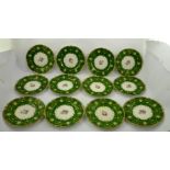 A ROYAL CROWN DERBY PART DESSERT SUITE having emerald green ground with polychrome floral