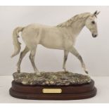 A ROYAL DOULTON BONE CHINA MODEL OF DESERT ORCHID, strolling on a naturalistic porcelain base with