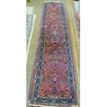 A PERSIAN DESIGN RUNNER having pink ground with stylised floral decoration in blue and green, deeply